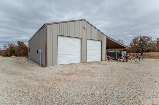 garage featuring a garage and dirt driveway