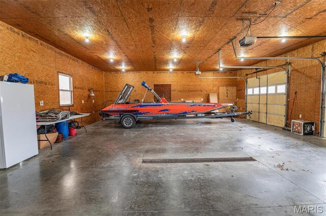 1106 W Parkview Dr, Belle, MO 65013 - garage with freestanding refrigerator and a garage door opener