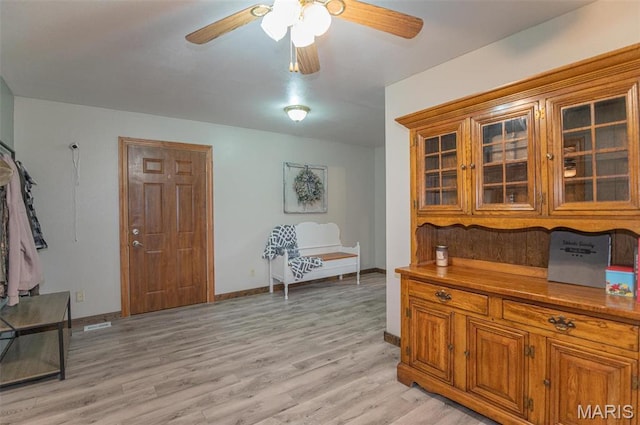 1106 W Parkview Dr, Belle, MO 65013 - living area featuring a ceiling fan, light wood finished floors, and baseboards