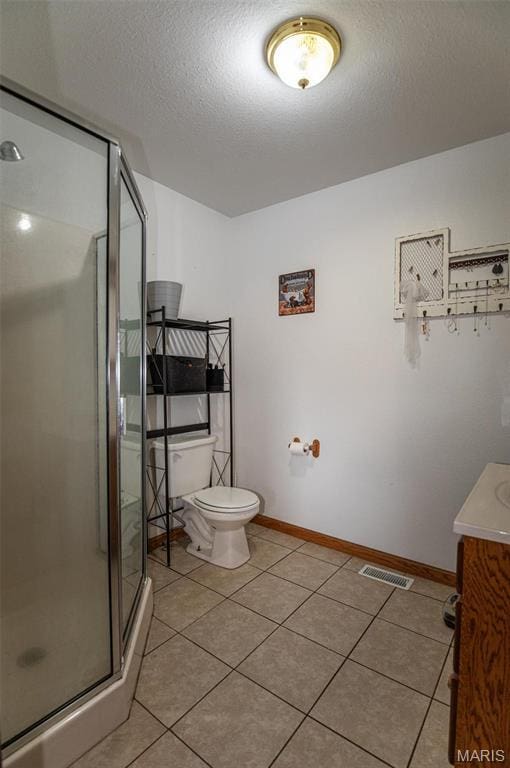 1106 W Parkview Dr, Belle, MO 65013 - bathroom featuring toilet, vanity, a stall shower, tile patterned flooring, and a textured ceiling