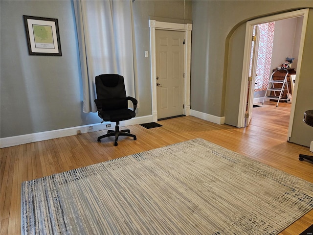 1324 Lebanon Ave, Belleville, IL 62221 - home office featuring baseboards, arched walkways, and light wood-style flooring