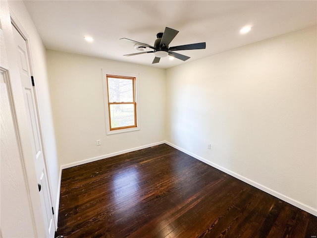 empty room with dark wood-type flooring, ceiling fan, baseboards, and recessed lighting