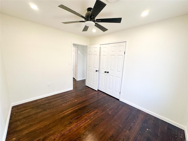 unfurnished bedroom featuring baseboards, dark wood finished floors, recessed lighting, a ceiling fan, and a closet