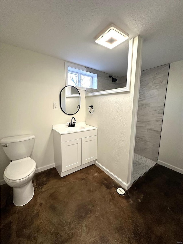 full bath with a textured ceiling, toilet, a walk in shower, vanity, and baseboards