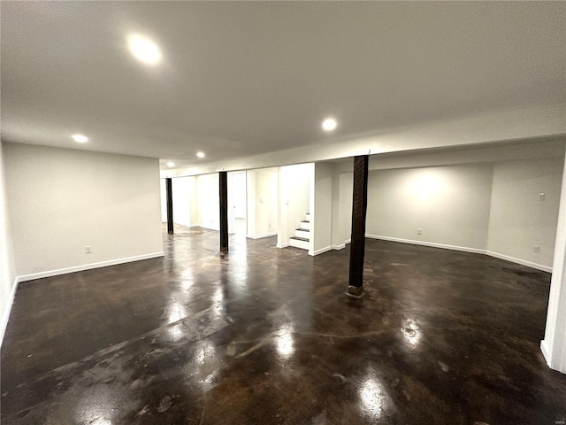 finished below grade area featuring recessed lighting, baseboards, and stairway
