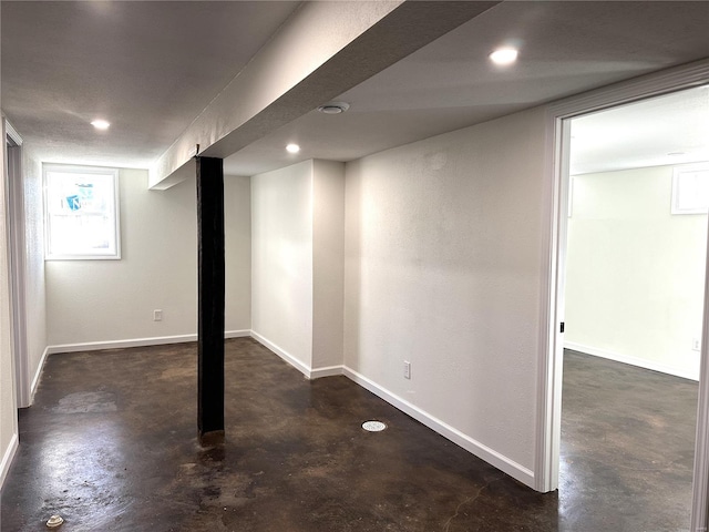 basement with baseboards and recessed lighting
