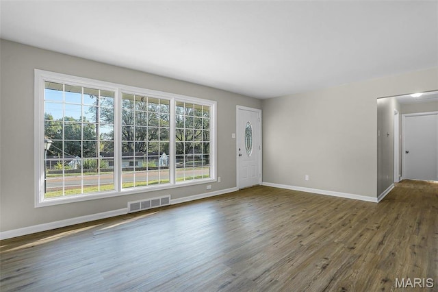 4000 Washington St, Florissant, MO 63033 - unfurnished living room featuring wood finished floors and baseboards