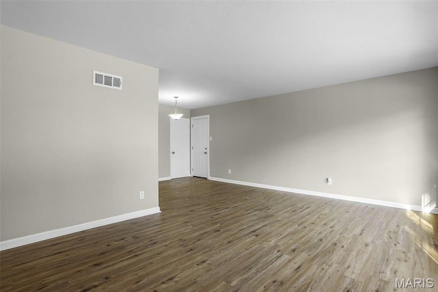 4000 Washington St, Florissant, MO 63033 - unfurnished room featuring dark wood-style floors and baseboards