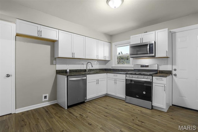 4000 Washington St, Florissant, MO 63033 - kitchen with stainless steel appliances, a sink, and white cabinetry