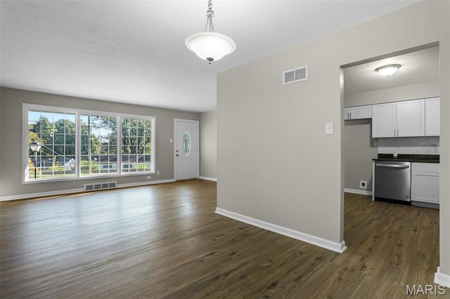 4000 Washington St, Florissant, MO 63033 - unfurnished living room with dark wood finished floors and baseboards