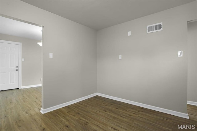 4000 Washington St, Florissant, MO 63033 - spare room featuring baseboards and dark wood-style floors