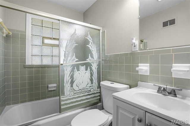 4000 Washington St, Florissant, MO 63033 - full bath with combined bath / shower with glass door, toilet, vanity, and tile walls