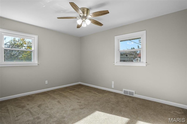 4000 Washington St, Florissant, MO 63033 - spare room with carpet flooring, healthy amount of natural light, baseboards, and a ceiling fan