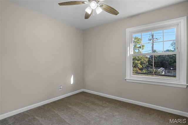 4000 Washington St, Florissant, MO 63033 - empty room featuring dark carpet, baseboards, and a ceiling fan