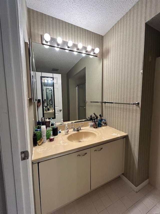 2314 Seven Pine Dr Unit 8, Saint Louis, MO 63146 - bathroom with wallpapered walls, a textured ceiling, tile patterned floors, vanity, and a stall shower