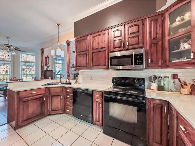 kitchen featuring black appliances, a sink, ornamental molding, light countertops, and a peninsula