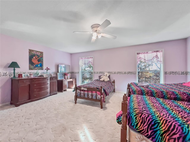 bedroom with carpet, a ceiling fan, and baseboards