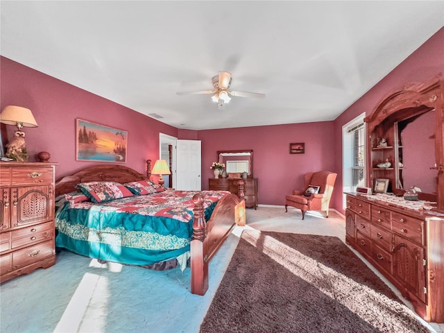 bedroom with light colored carpet and a ceiling fan