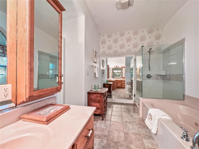 full bathroom with a shower stall, vanity, a garden tub, and tile patterned floors