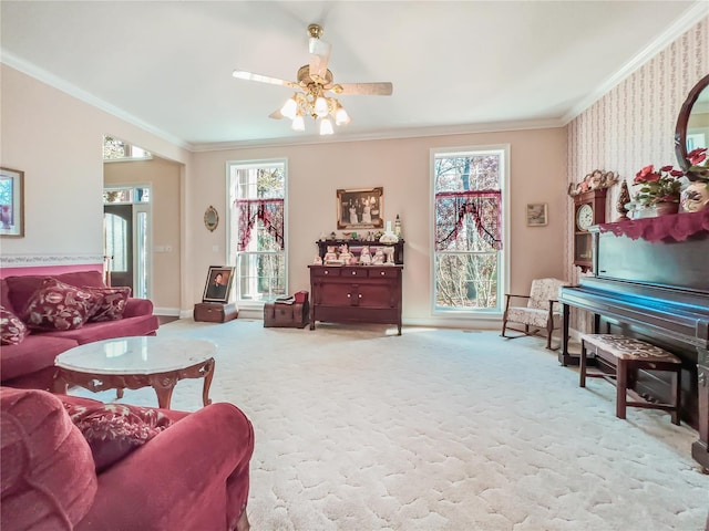 living area featuring ornamental molding, ceiling fan, baseboards, and carpet floors