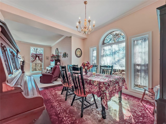 dining space with crown molding, a chandelier, healthy amount of natural light, and wood finished floors