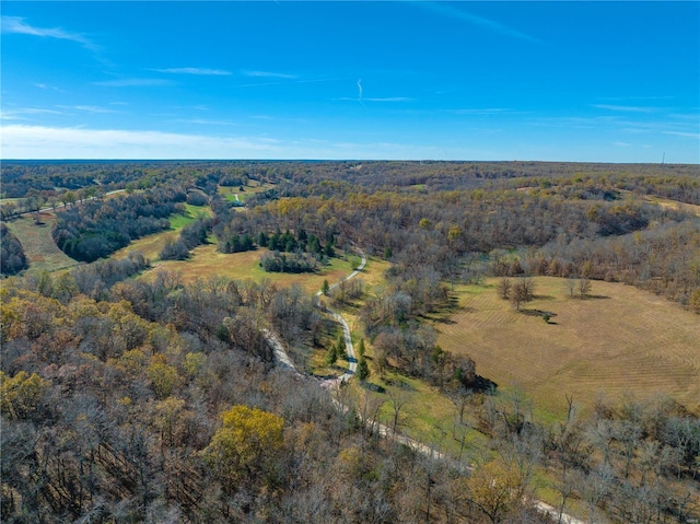 aerial view of property's location featuring a heavily wooded area