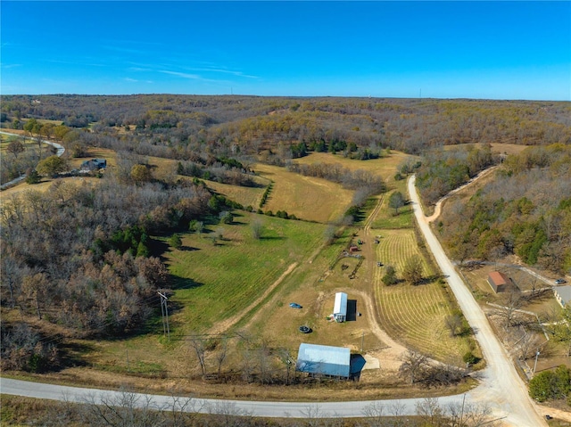 aerial view of property and surrounding area with rural landscape and a forest