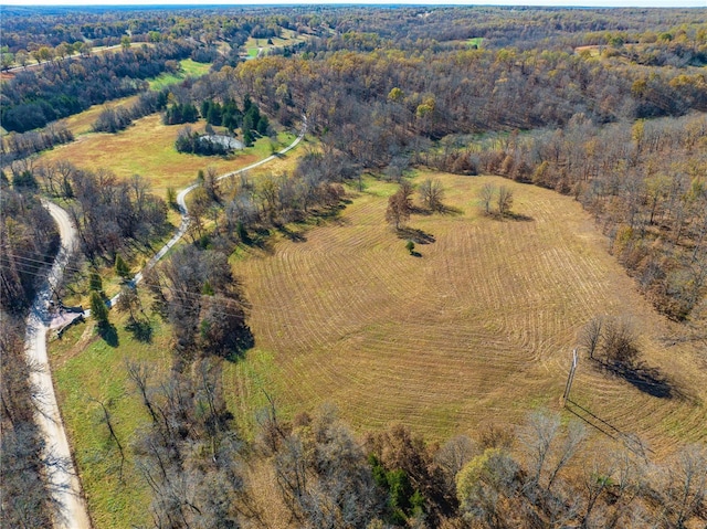 aerial view of property and surrounding area with a forest