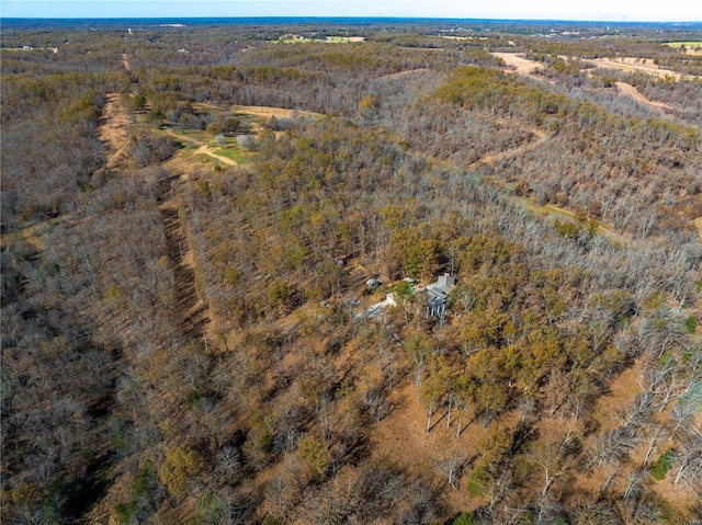 aerial view of property's location featuring a heavily wooded area