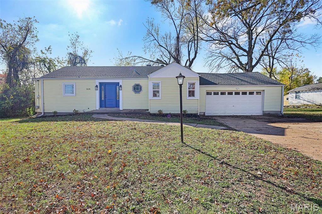 1624 Talisman Ln, Saint Louis, MO 63138 - ranch-style home with concrete driveway, a garage, and a front lawn