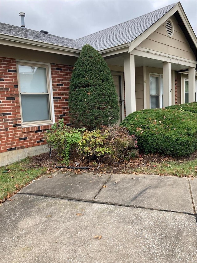 6550 E Dolphin Cir E, Florissant, MO 63033 - view of home's exterior featuring brick siding and roof with shingles
