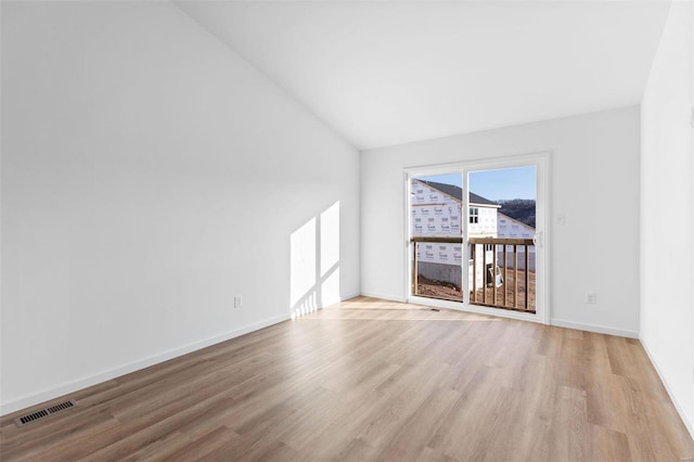 1064 Vardon Meadows Dr, Union, MO 63084 - empty room featuring wood finished floors, vaulted ceiling, and baseboards