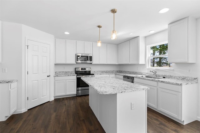3139 White Pine Dr, Imperial, MO 63052 - kitchen with stainless steel appliances, a sink, a center island, white cabinets, and recessed lighting