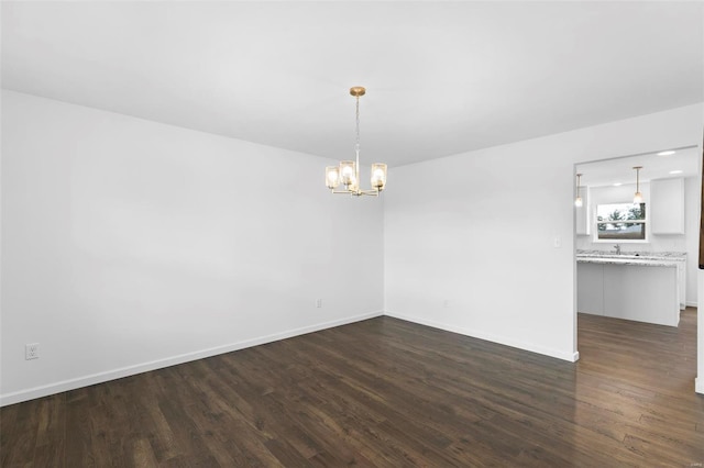 3139 White Pine Dr, Imperial, MO 63052 - empty room with a chandelier, dark wood-style floors, baseboards, and a sink