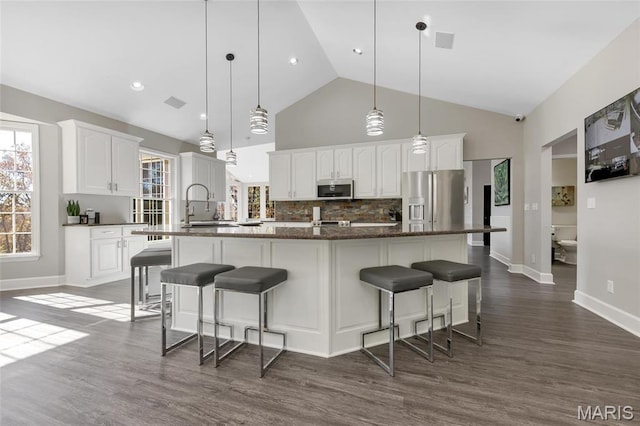 809 Peruque View Ct, Wentzville, MO 63385 - kitchen featuring stainless steel appliances, a sink, tasteful backsplash, a large island with sink, and dark wood-type flooring