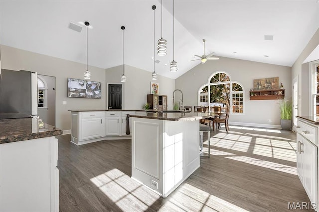 809 Peruque View Ct, Wentzville, MO 63385 - kitchen featuring freestanding refrigerator, a sink, a ceiling fan, wood finished floors, and a center island with sink