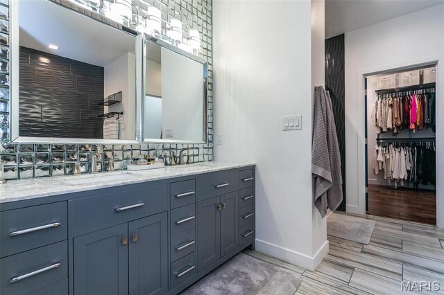 3723 Cabernet Ln, Edwardsville, IL 62025 - full bath with vanity, baseboards, decorative backsplash, and a walk in closet