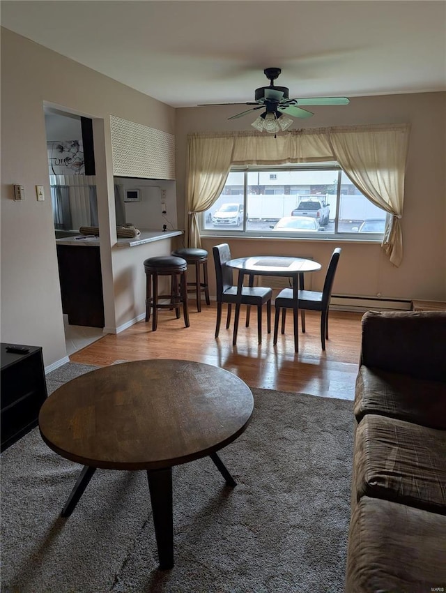 living area with ceiling fan and light wood finished floors