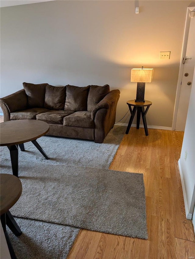 living area with wood finished floors and baseboards