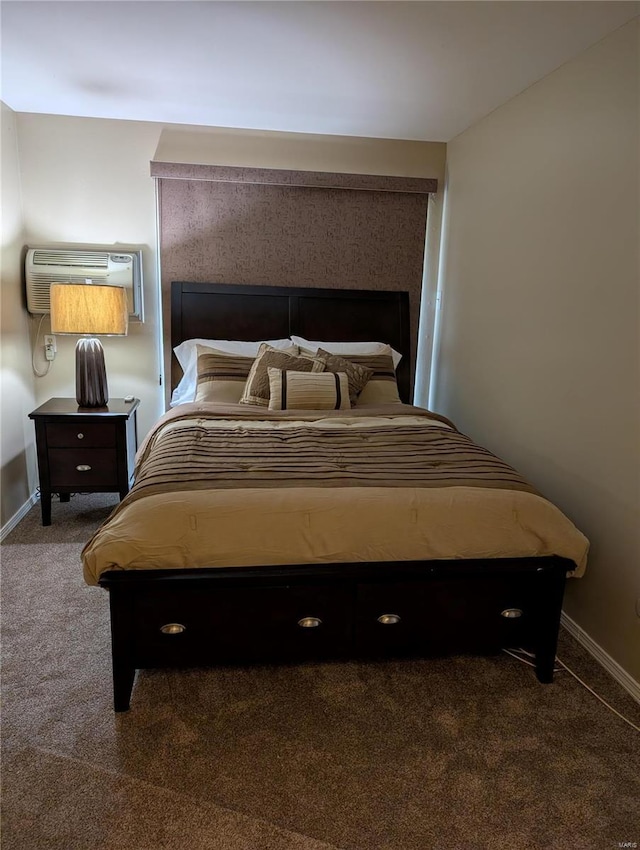 bedroom with carpet, an AC wall unit, and baseboards