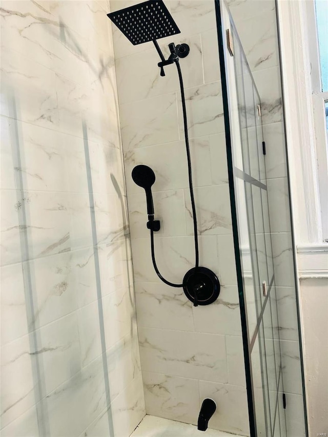 bathroom with a marble finish shower