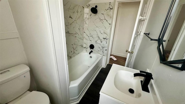 full bathroom featuring toilet, washtub / shower combination, and vanity