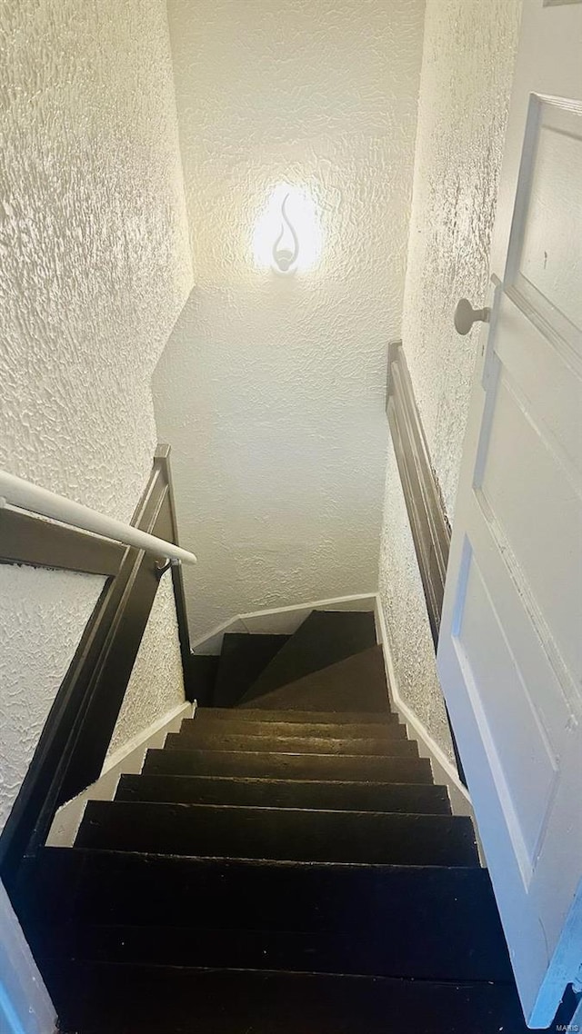 stairs with a textured wall