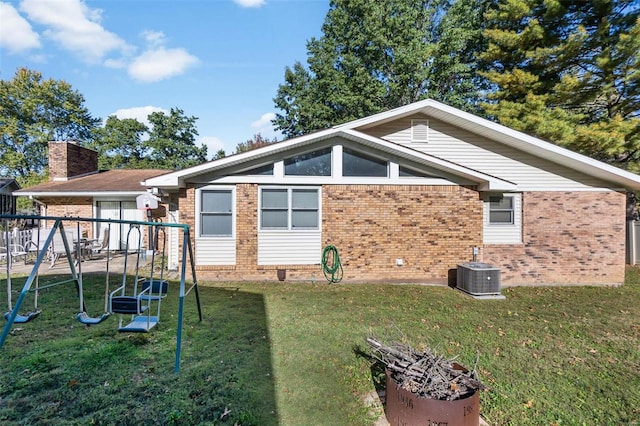 2230 Kent Dr, Cape Girardeau, MO 63701 - back of house featuring a playground, brick siding, a yard, central AC unit, and a chimney