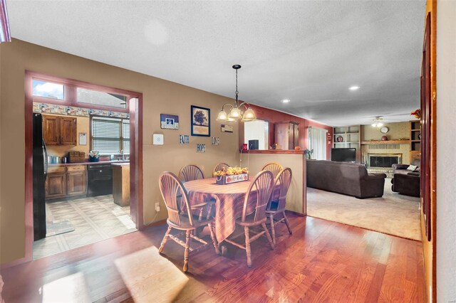 2230 Kent Dr, Cape Girardeau, MO 63701 - dining room with light wood-type flooring, a fireplace, ceiling fan, recessed lighting, and a textured ceiling