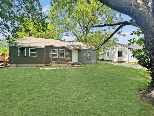 800 NW Capelle St, Grain Valley, MO 64029 - rear view of property featuring a lawn and roof with shingles