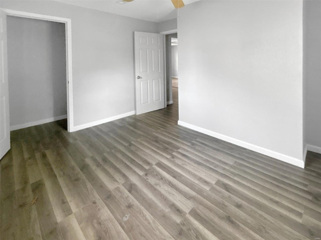 800 NW Capelle St, Grain Valley, MO 64029 - unfurnished bedroom featuring baseboards, wood finished floors, a closet, and a ceiling fan