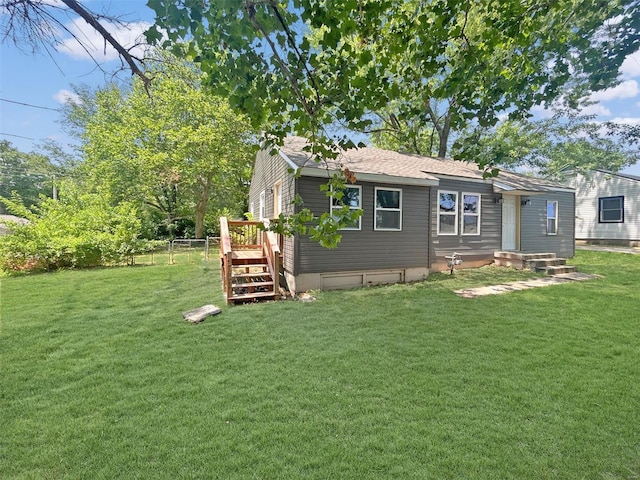 800 NW Capelle St, Grain Valley, MO 64029 - rear view of property with a lawn and a shingled roof