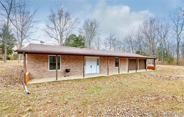 10994 Webster Rd, Caledonia, MO 63631 - back of property with a patio, brick siding, and a garage