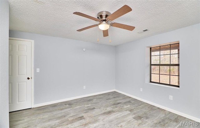 10994 Webster Rd, Caledonia, MO 63631 - empty room with wood finished floors, a textured ceiling, and a ceiling fan